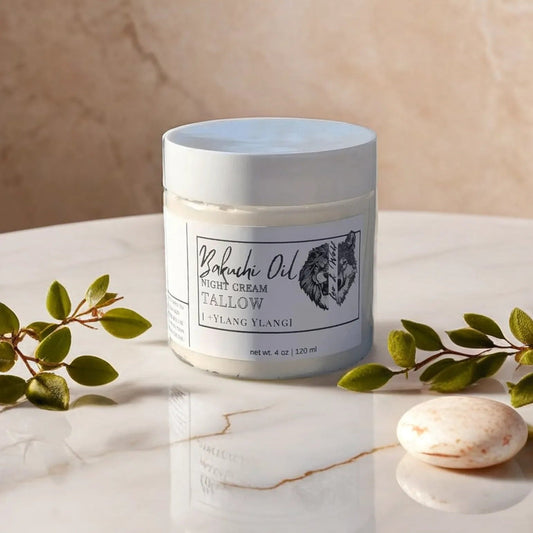 Jar of night cream on a marble surface with green leaves