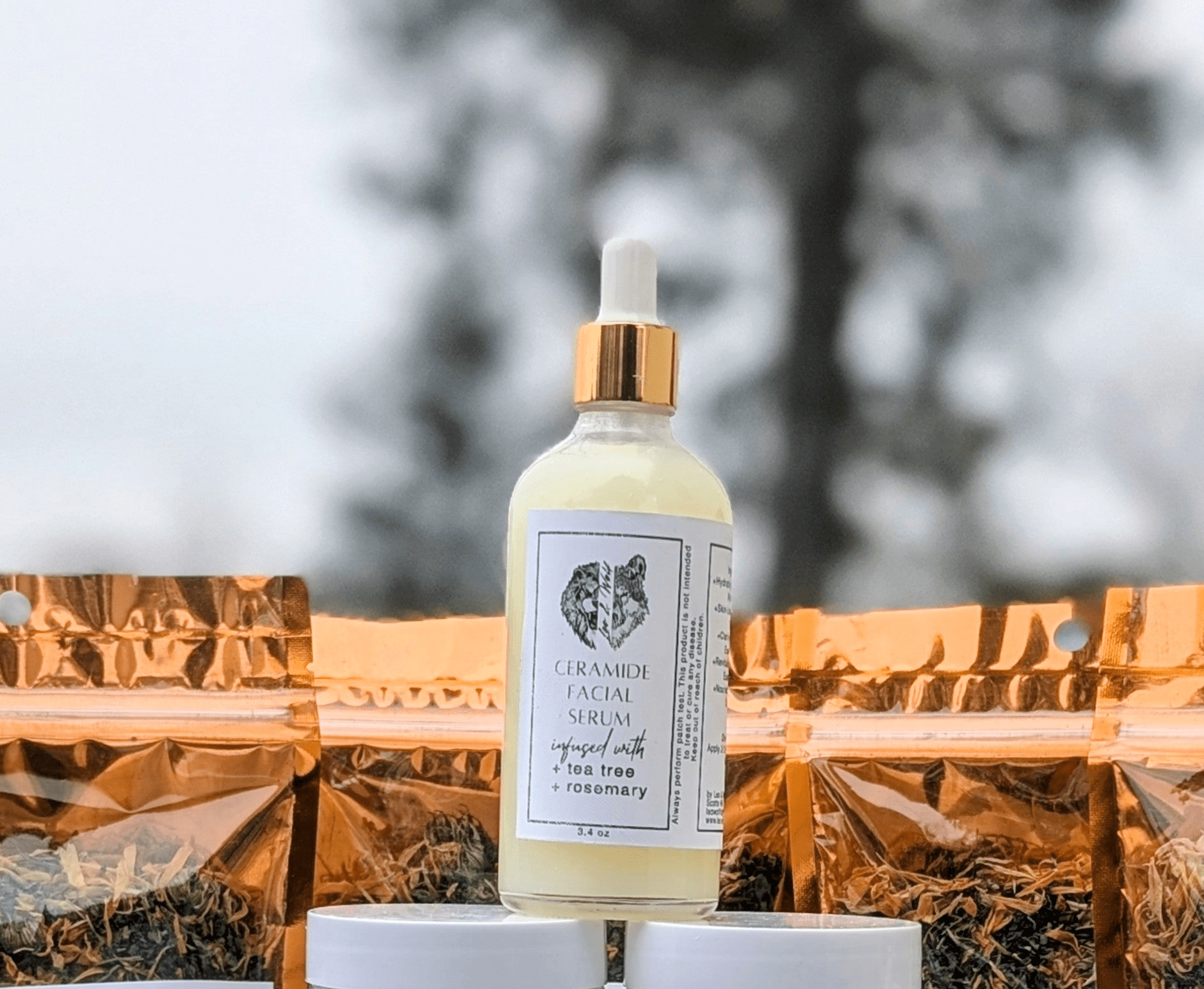 Collection of natural skincare products and tea bags on a surface outdoors.