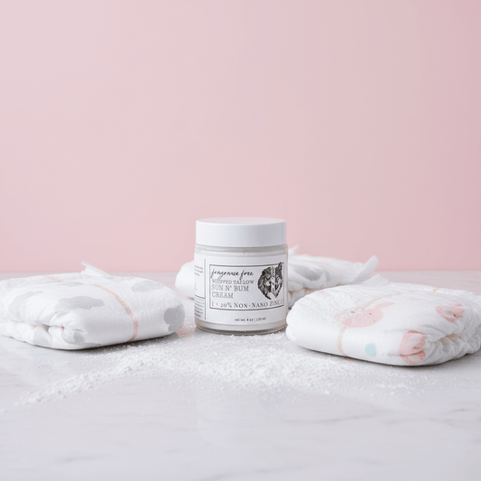 Jar of cream with baby blankets on a light pink background